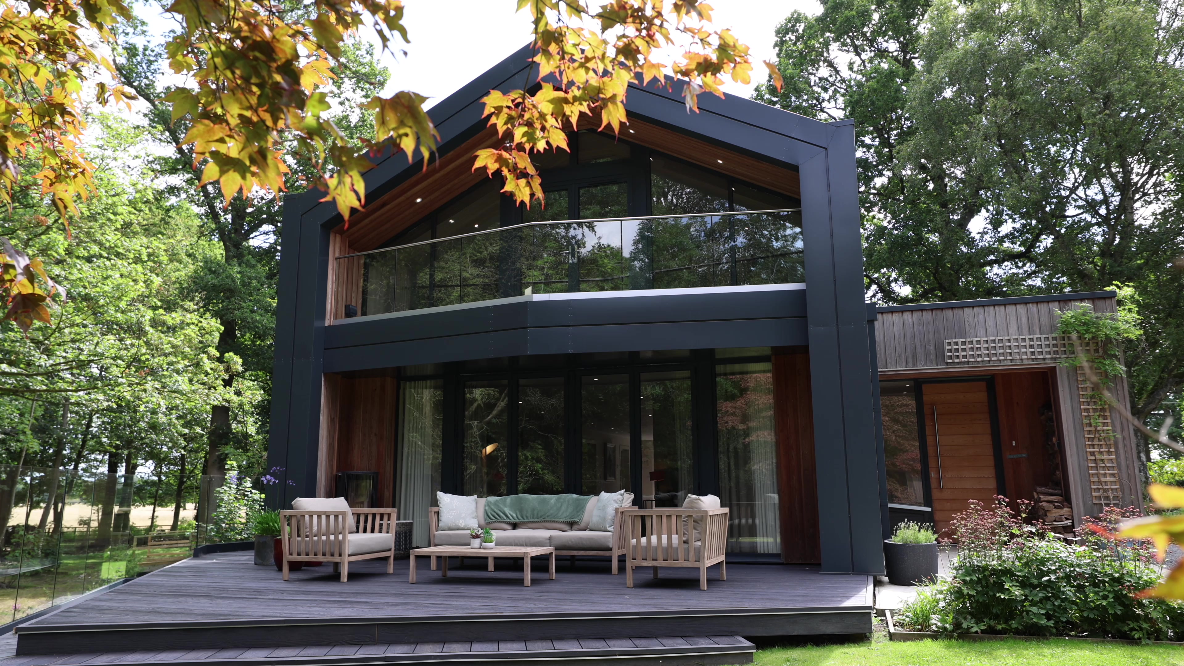 Contemporary gabled home at High Beeches with glazed balcony, furnished terrace and surrounding woodland.